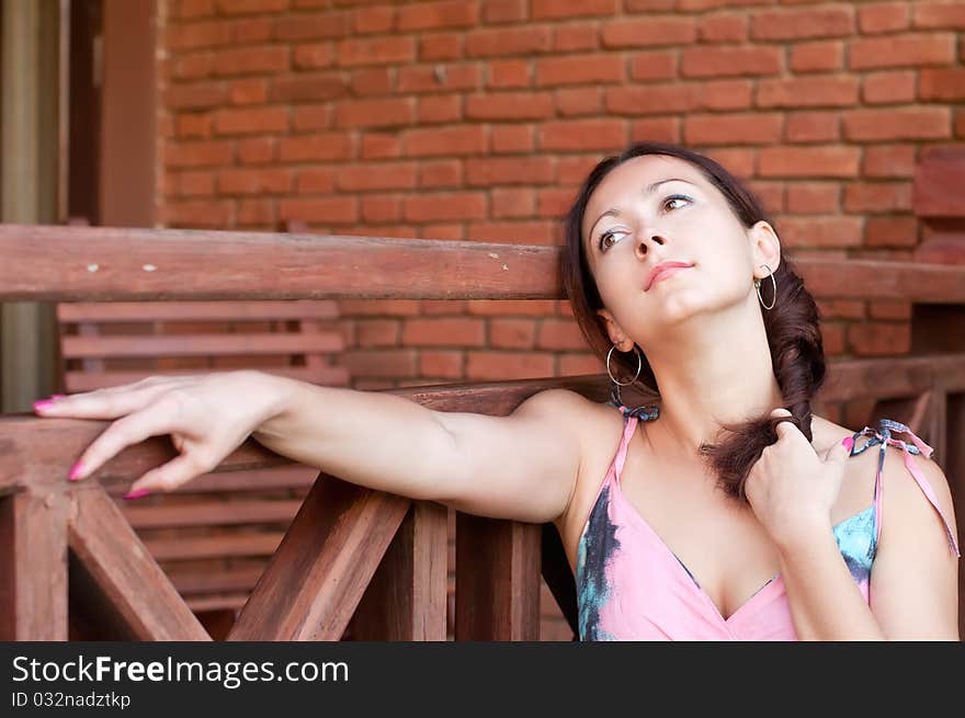 Dreaming woman near the brick wall