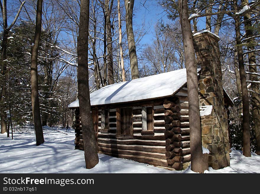 Old colonial style log cabin in winter snow. Old colonial style log cabin in winter snow