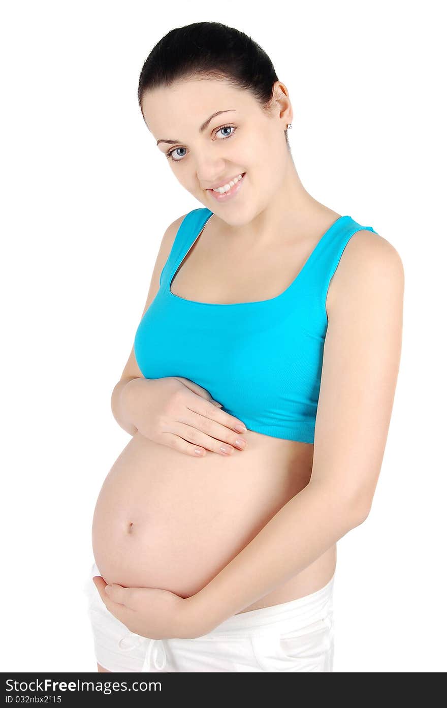 Young happy pregnant woman holding her belly isolated on white