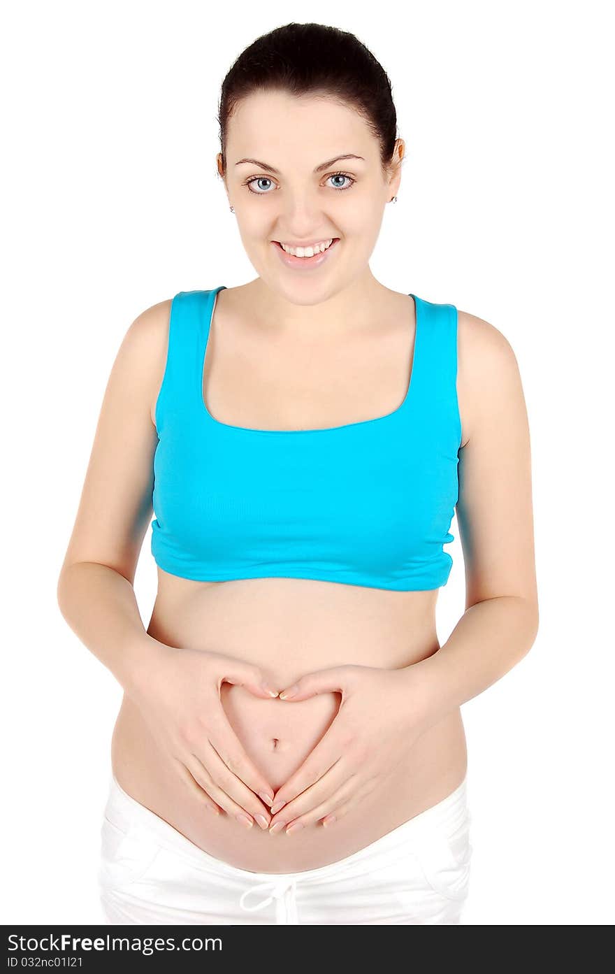 Happy young pregnant woman holding her belly heart shaped isolated on white