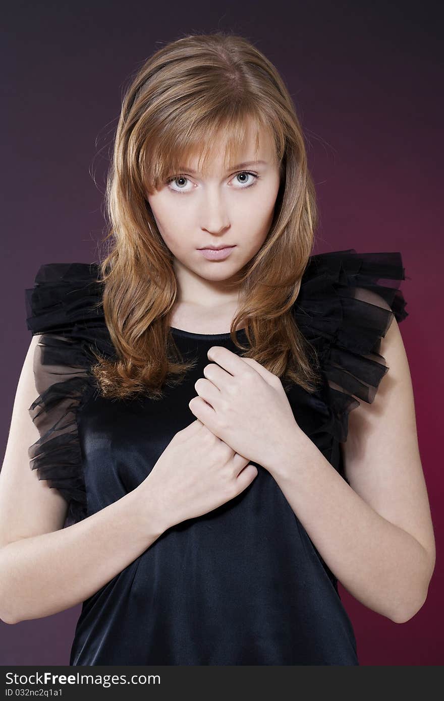 Portrait of a beautiful sensuality woman in black dress posing over red background