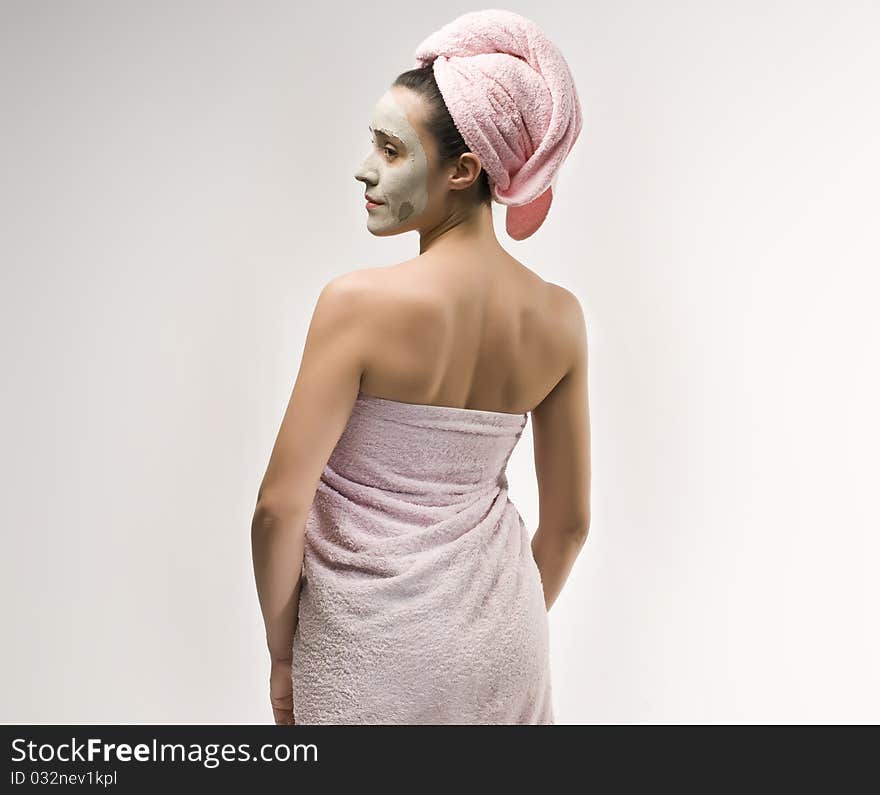 Woman with beauty mask wearing towels. Woman with beauty mask wearing towels