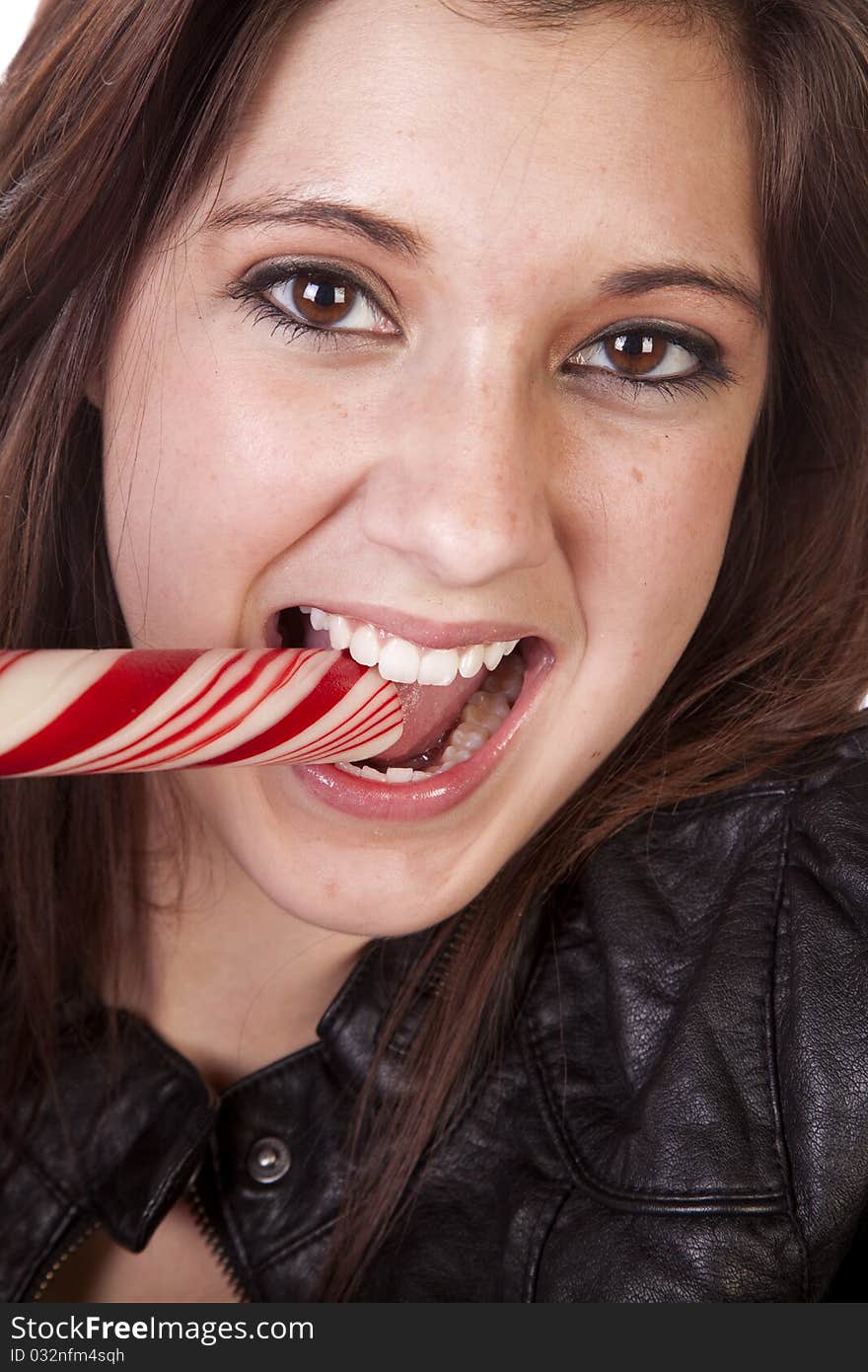 A close up of a woman eating a big round peppermint stick. A close up of a woman eating a big round peppermint stick.