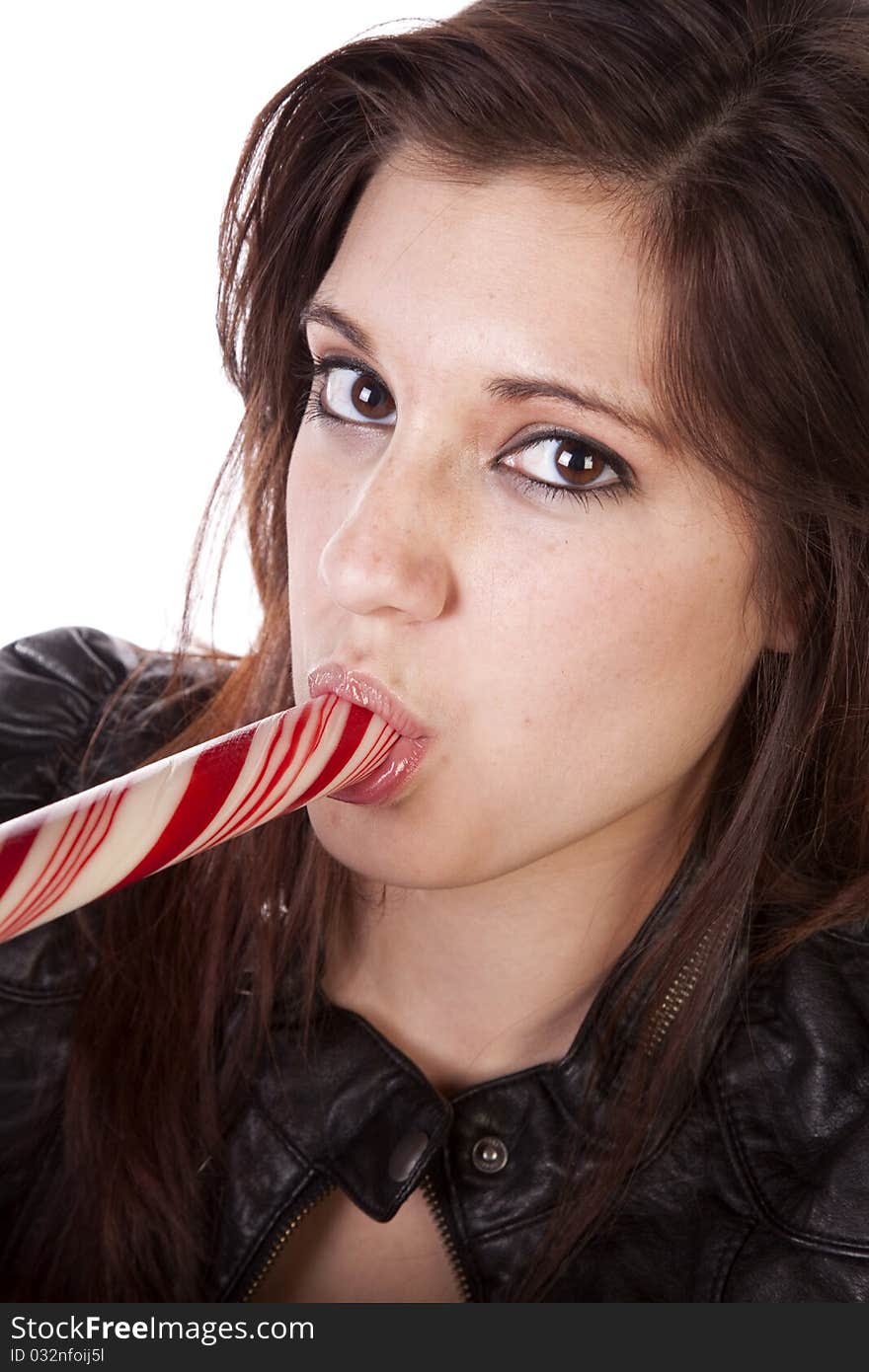 A close up of a woman eating a big round peppermint stick. A close up of a woman eating a big round peppermint stick.