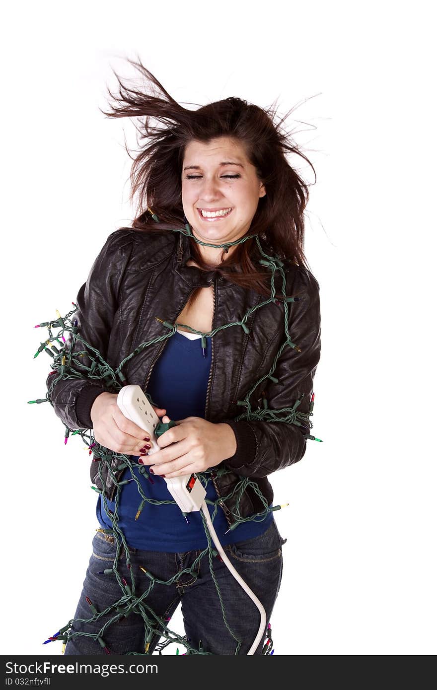 A woman feeling the full force of the Christmas season while she is wrapped up in Christmas lights getting shocked. A woman feeling the full force of the Christmas season while she is wrapped up in Christmas lights getting shocked.