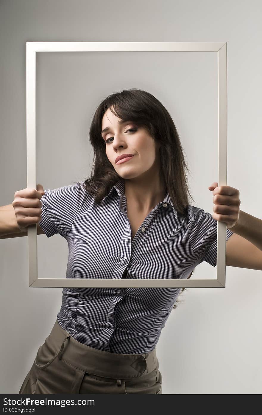 Beautiful woman holding an empty frame. Beautiful woman holding an empty frame