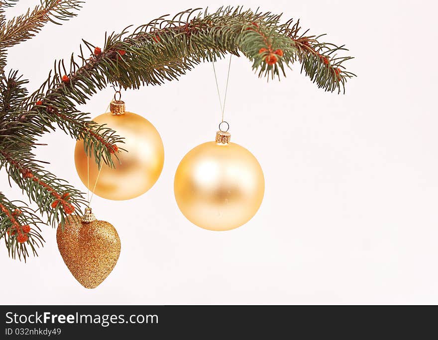 Golden globes and Christmas decorations on the tree branch