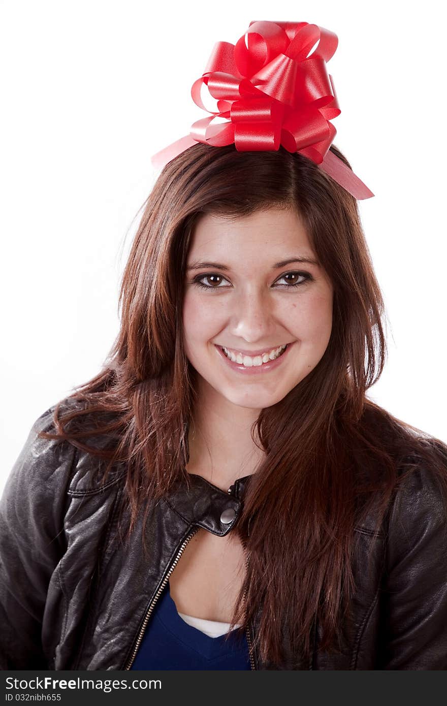 A woman wearing a red gift bow on her head with a big smile on her face. A woman wearing a red gift bow on her head with a big smile on her face.