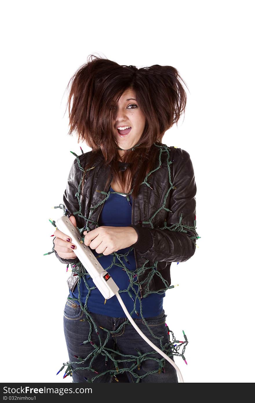 A woman all tied up in Christmas lights with a shocked expression on her face and her hair standing up on end. A woman all tied up in Christmas lights with a shocked expression on her face and her hair standing up on end.