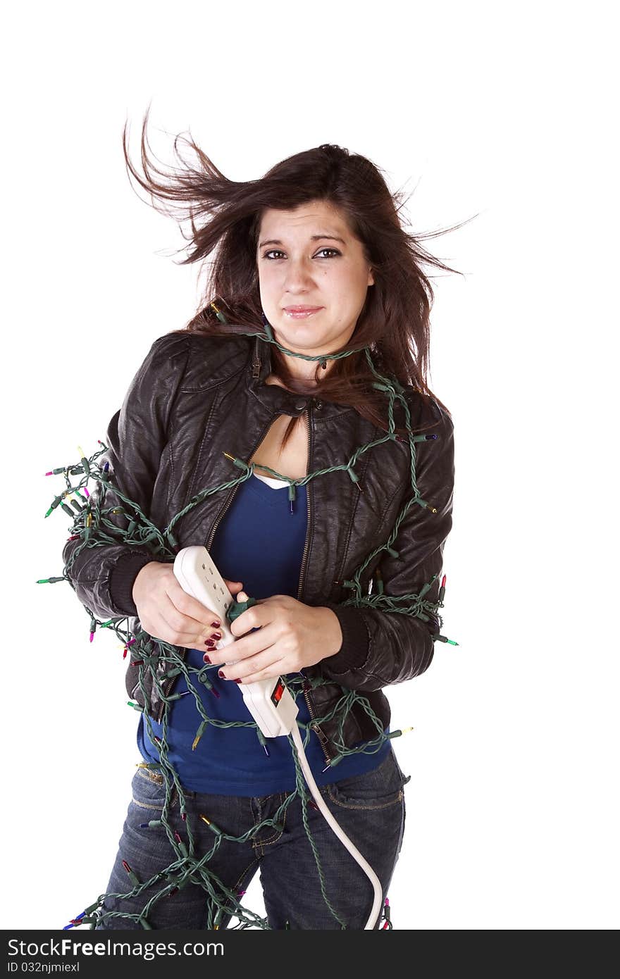 A woman all tied up in a bunch of Christmas lights holding her breath while she plugs in the lights with her hair slowly standing up on end. A woman all tied up in a bunch of Christmas lights holding her breath while she plugs in the lights with her hair slowly standing up on end.