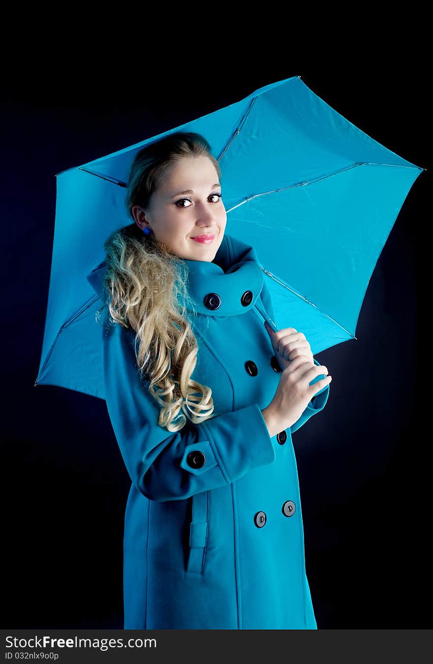 Young girl in coat  with blue umbrella. Young girl in coat  with blue umbrella