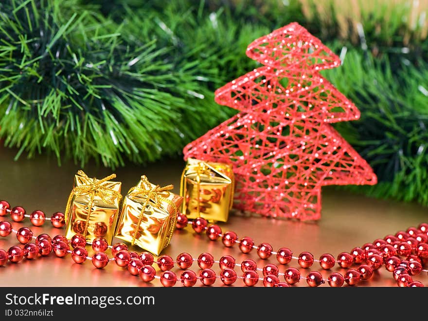 Christmas still life with golden gift boxes and red new year's tree