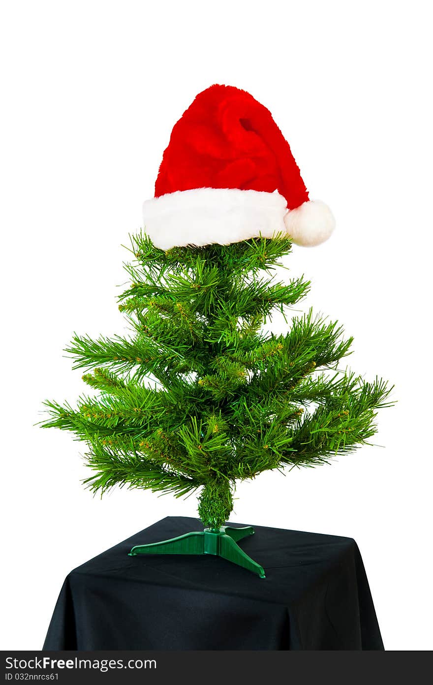 Xmas tree with red hat on white background. Xmas tree with red hat on white background