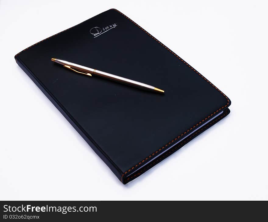 Opened book, diary and pen with blank pages isolated over white background