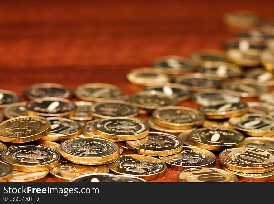 Golden coins on a wooden table