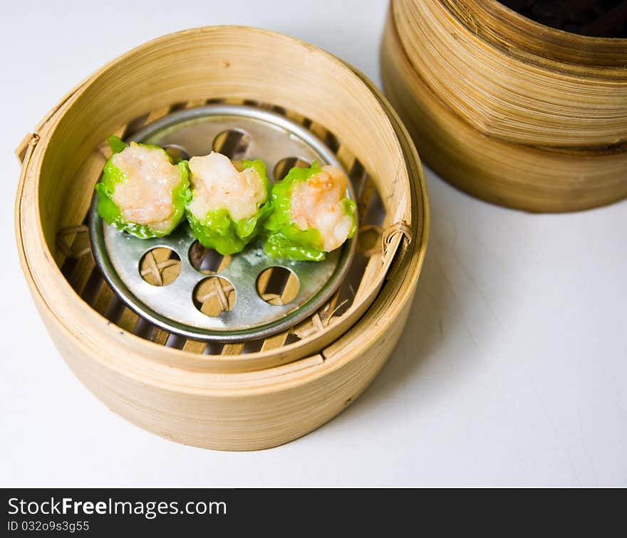 Chinese steamed dimsum in bamboo containers traditional cuisine. Chinese steamed dimsum in bamboo containers traditional cuisine