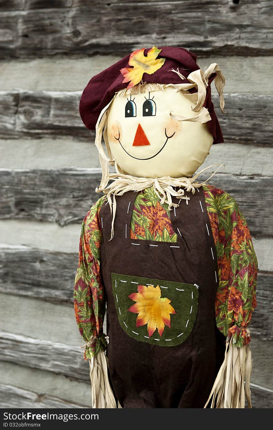 A cute smiling scarecrow, vertical with copy space. A cute smiling scarecrow, vertical with copy space