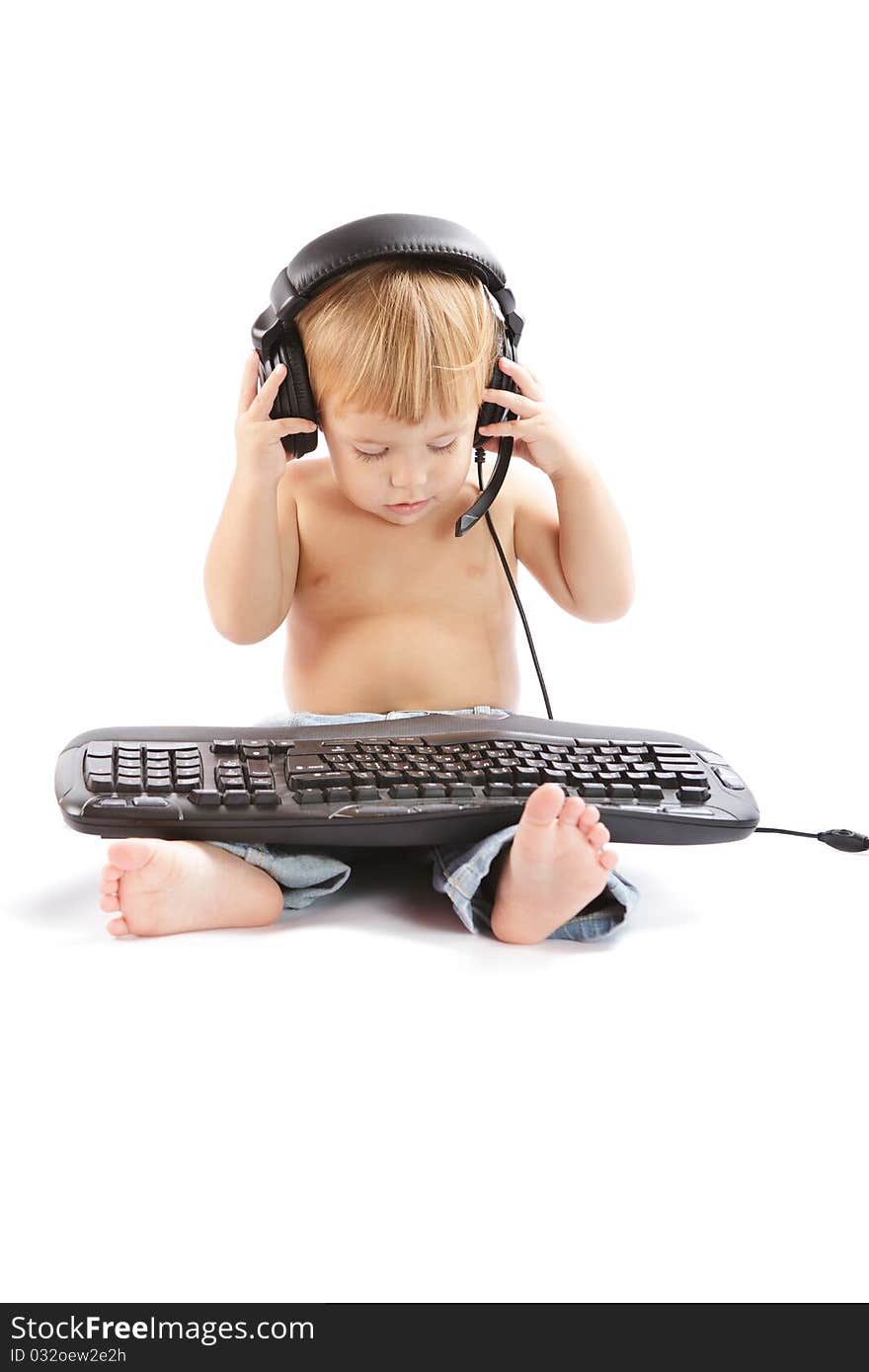 Little boy with headphones and keyboard. Little boy with headphones and keyboard