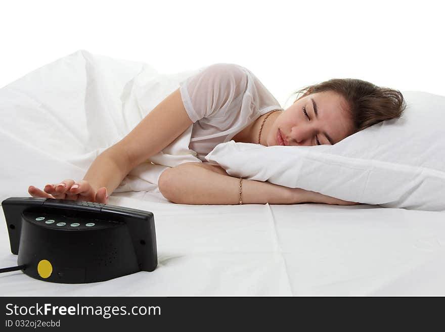 Woman in a bed with alarm clock