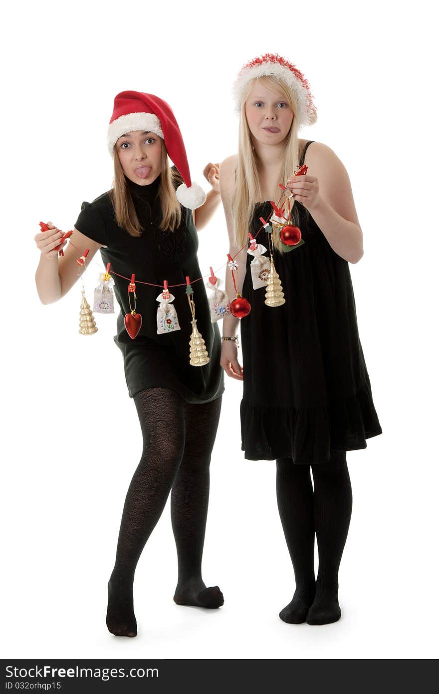 Two girls in the Santa hat and gifts on a white background