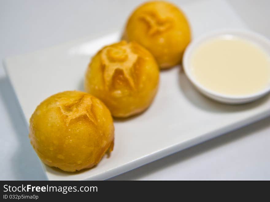 Fried Sweet Cream Bun on dish. Fried Sweet Cream Bun on dish