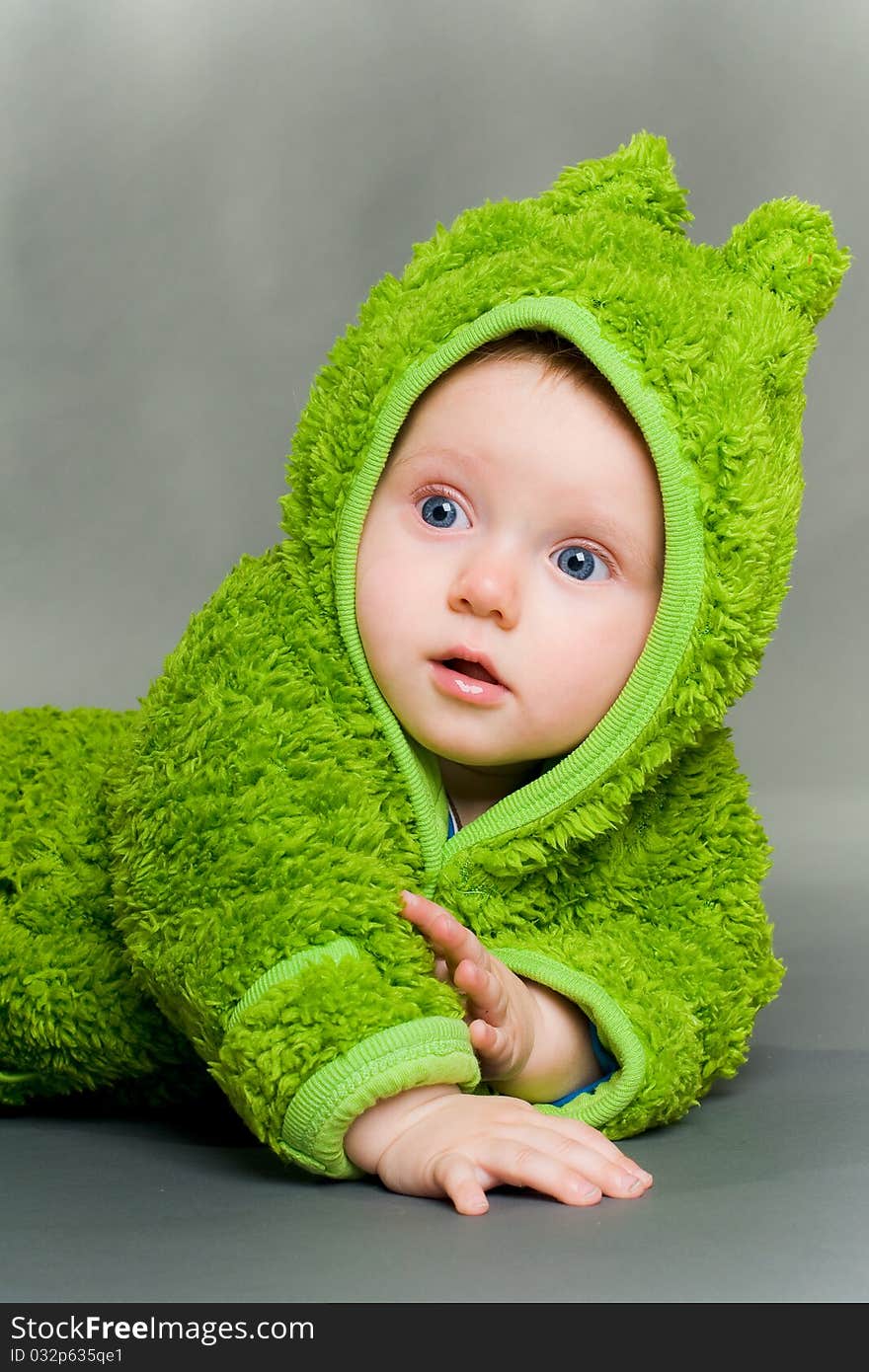 Sweet cute baby dressed in a frog suit. Sweet cute baby dressed in a frog suit