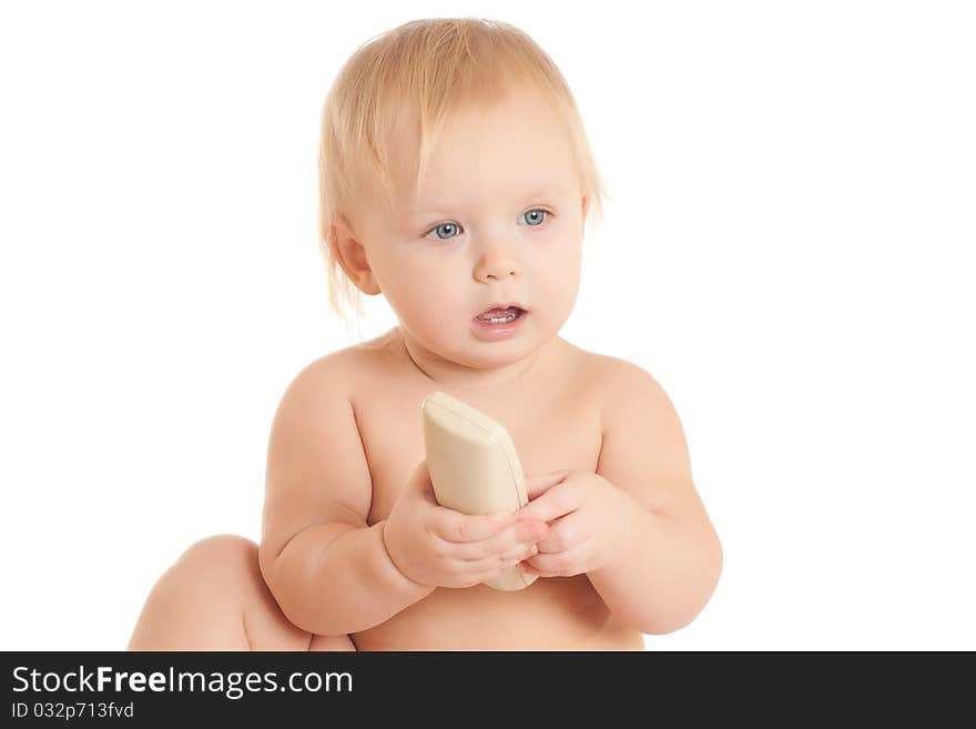 Young sitting baby with phone in hand