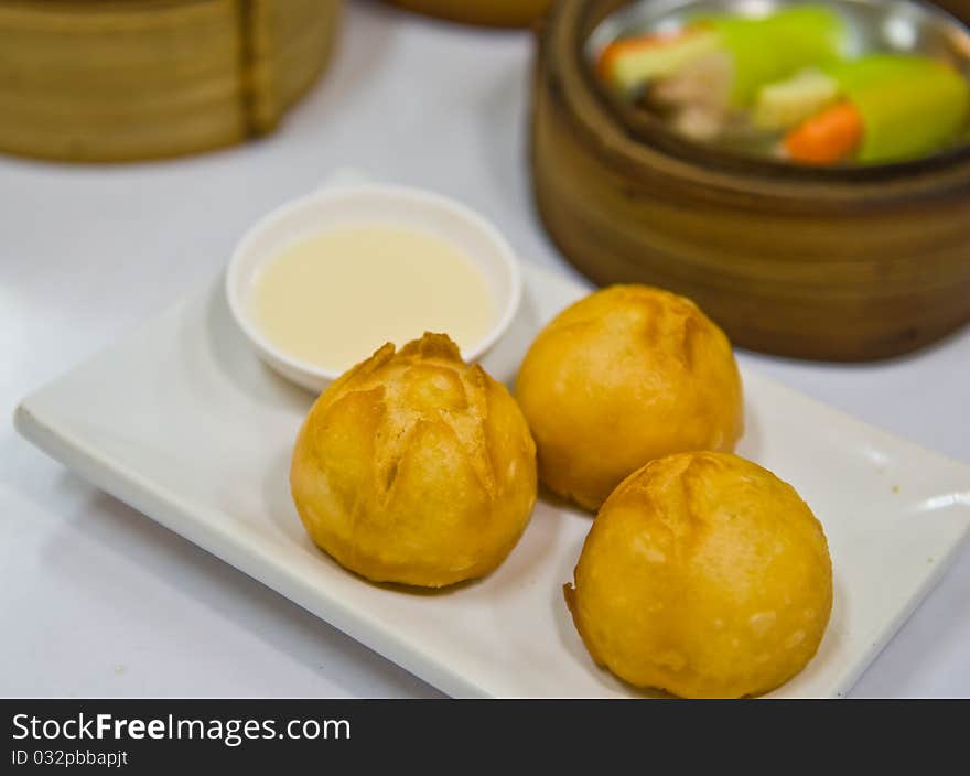 Fried Sweet Cream Bun on dish. Fried Sweet Cream Bun on dish