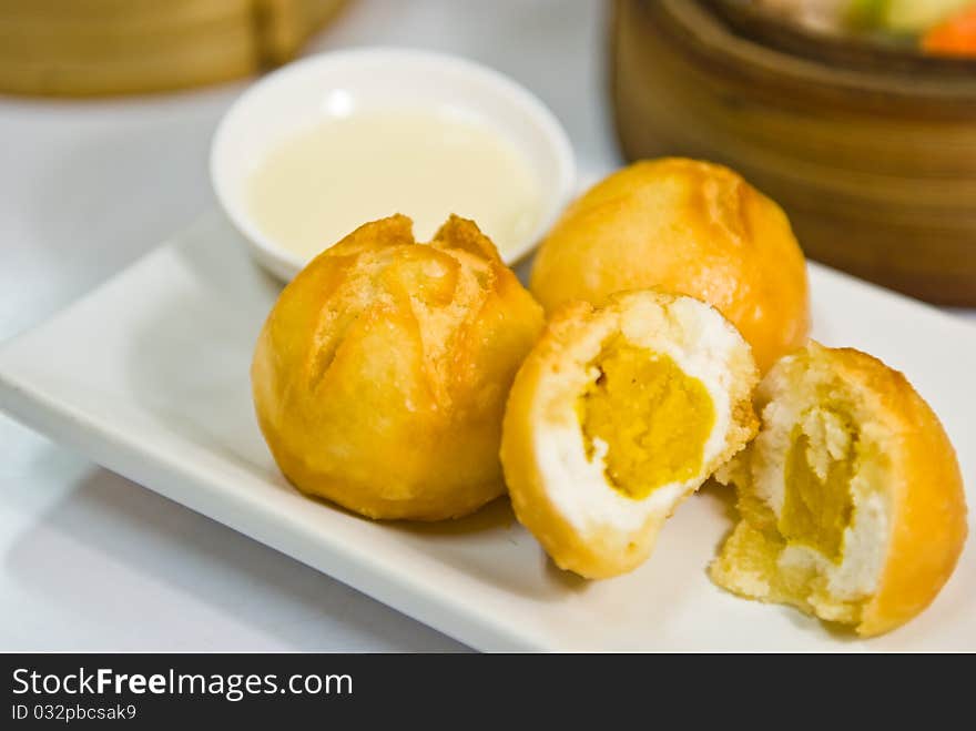 Fried Sweet Cream Bun on dish. Fried Sweet Cream Bun on dish