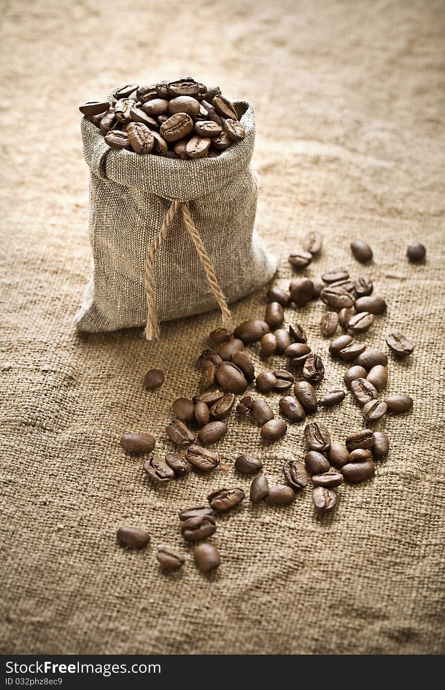 Coffee beans in bag of burlap on sacking. Coffee beans in bag of burlap on sacking