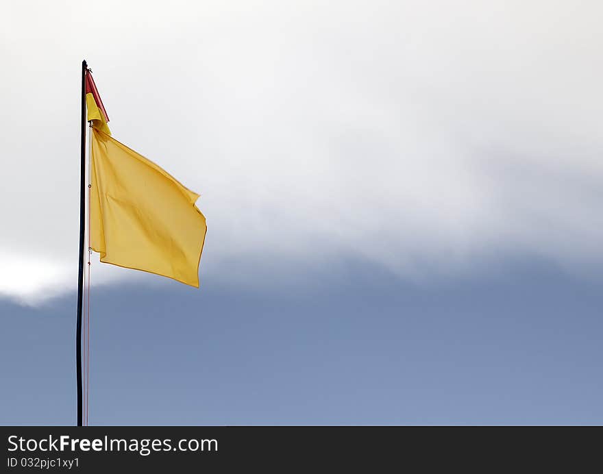 A red and yellow swimming safety flag on an Lithuanian beach