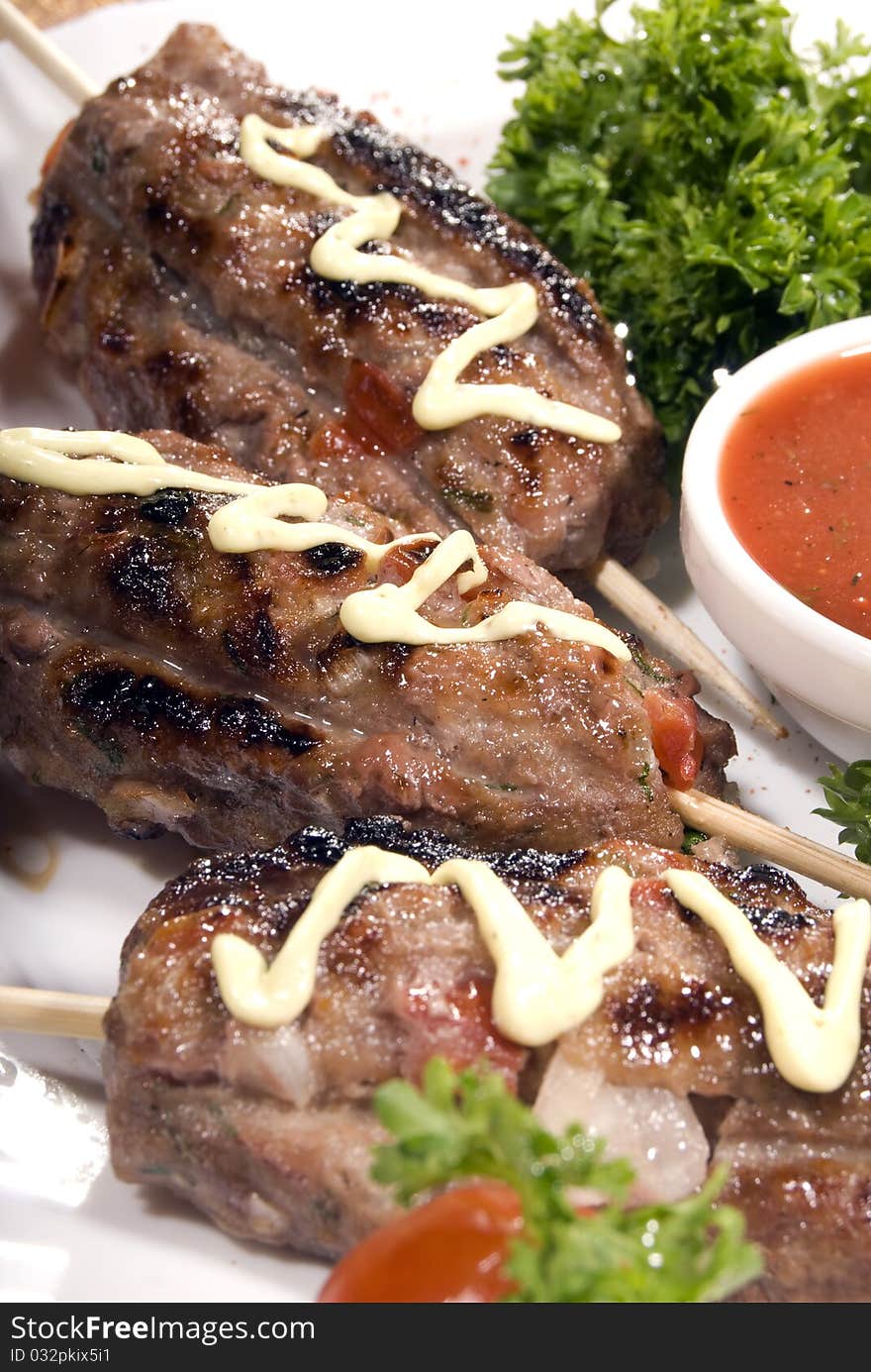 Fried meat served with tomato sauce and salad