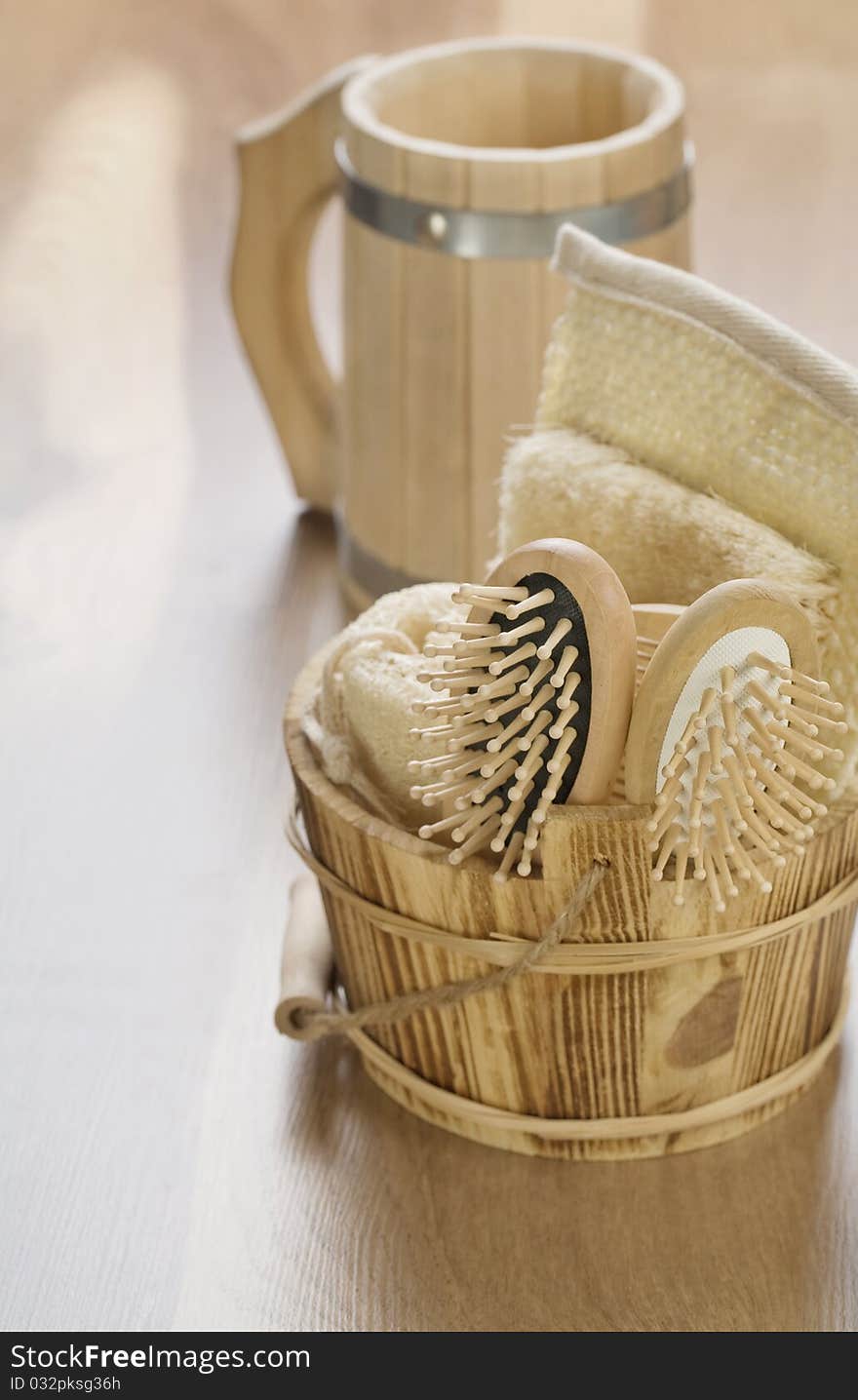 Bucket and mug on wooden background