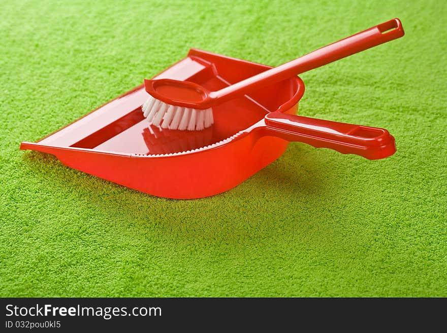 Dustpan with brush on green towel