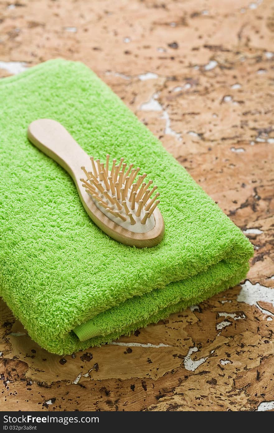 Hairbrush and towel on cork wood