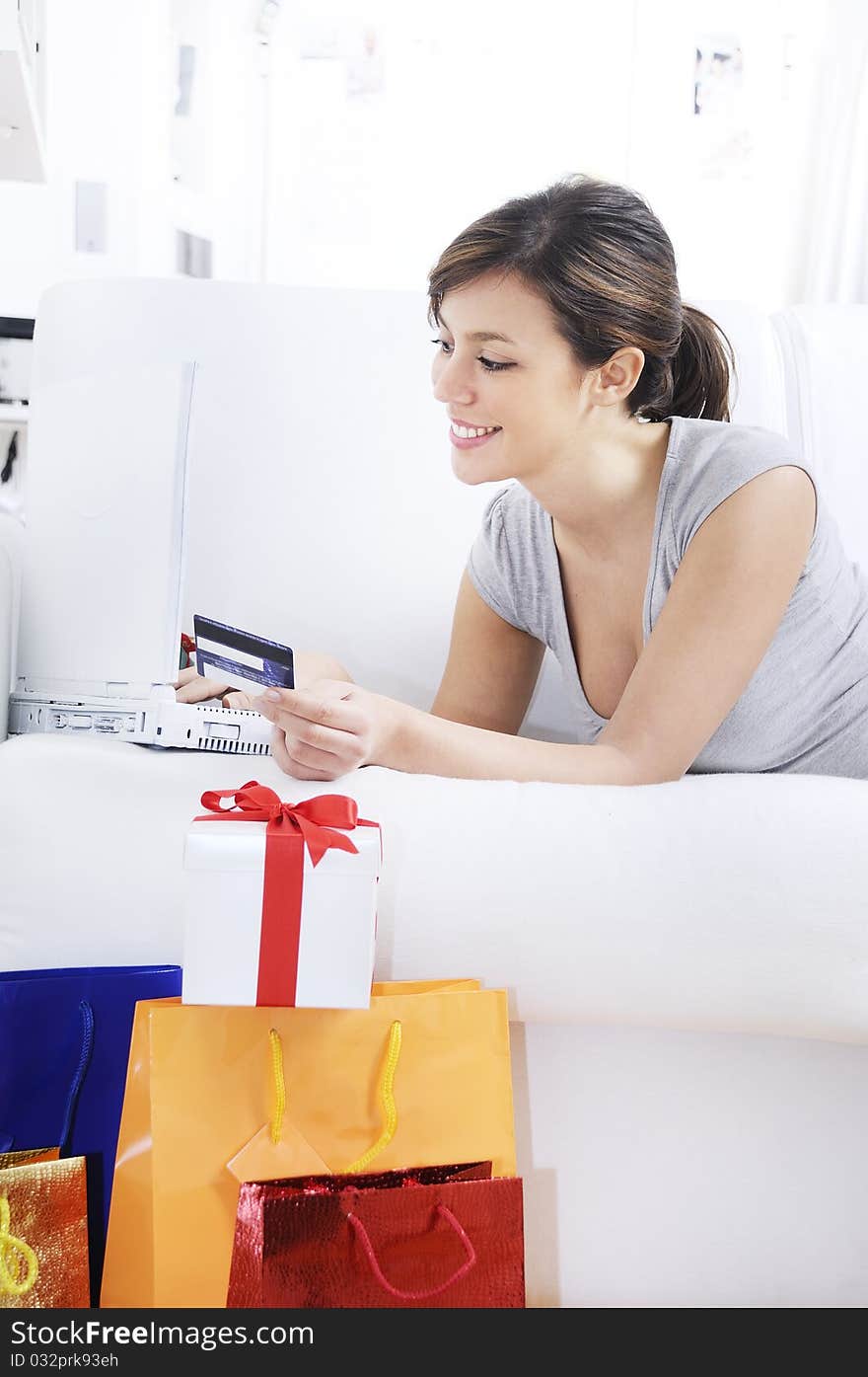 Happy shopping on-line of young woman with laptop on internet. Happy shopping on-line of young woman with laptop on internet