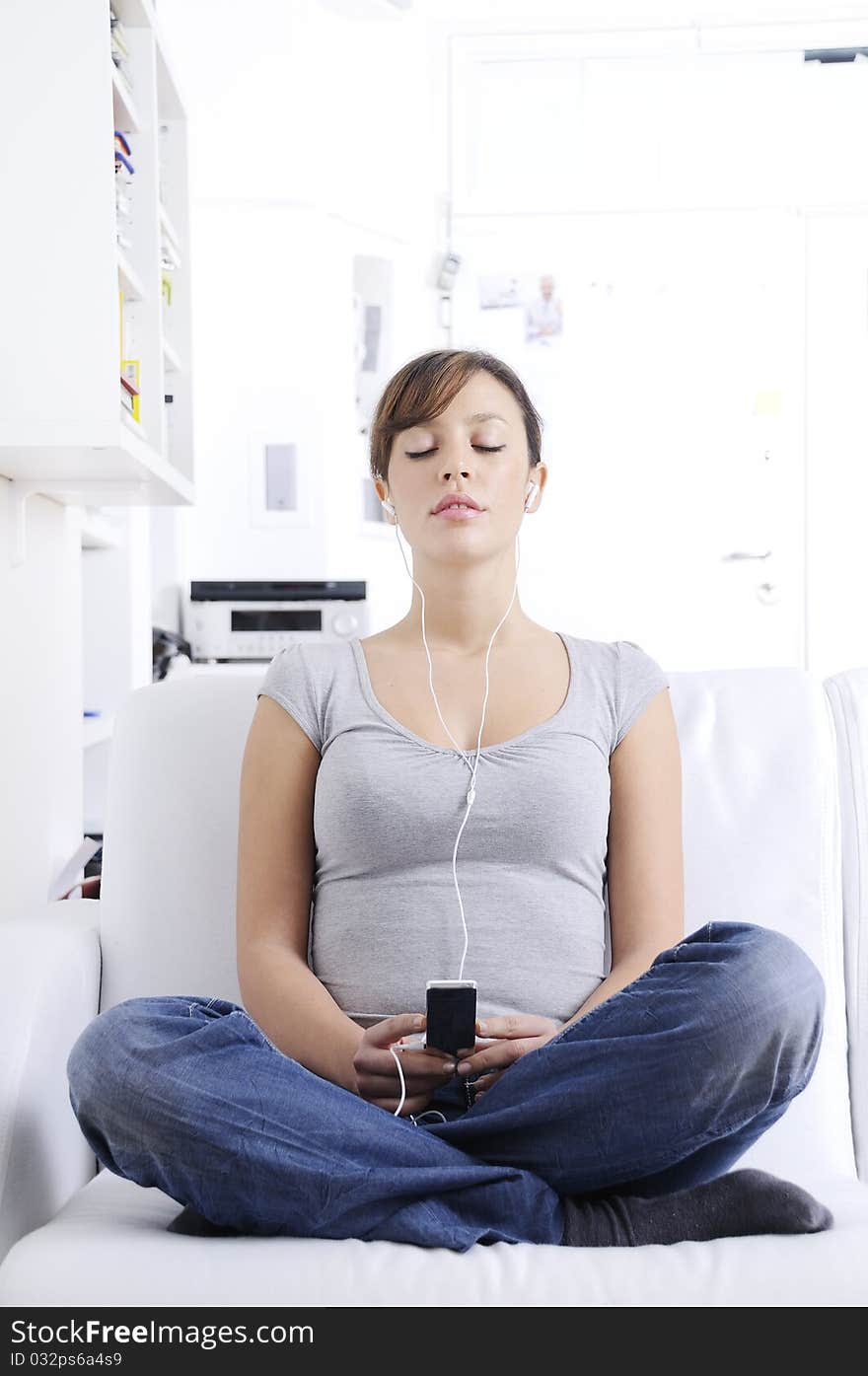 Young Woman Listening Music In Home Interior