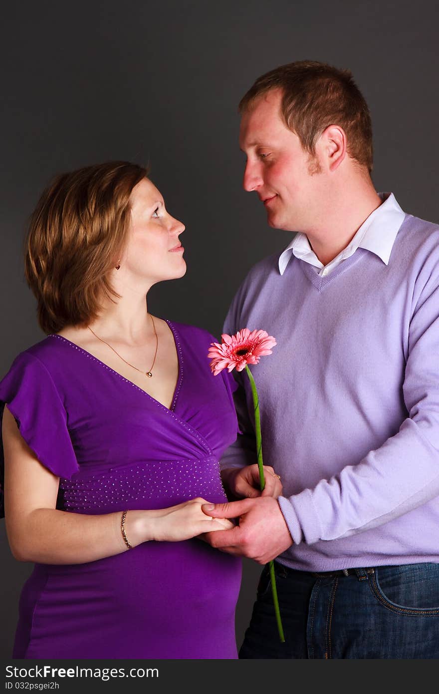 Pregnant woman with flower and her husband. Pregnant woman with flower and her husband