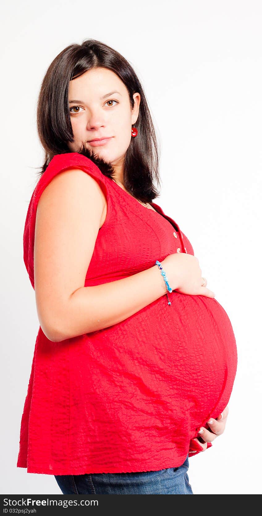 Beautiful pregnant woman staing on light grey background