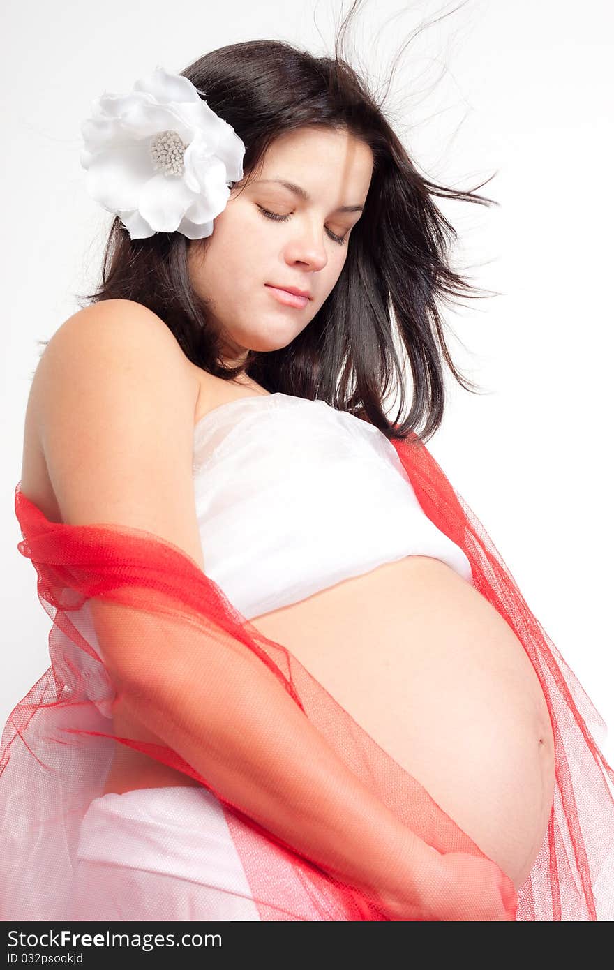 Beautiful pregnant woman staing on light grey background, close up