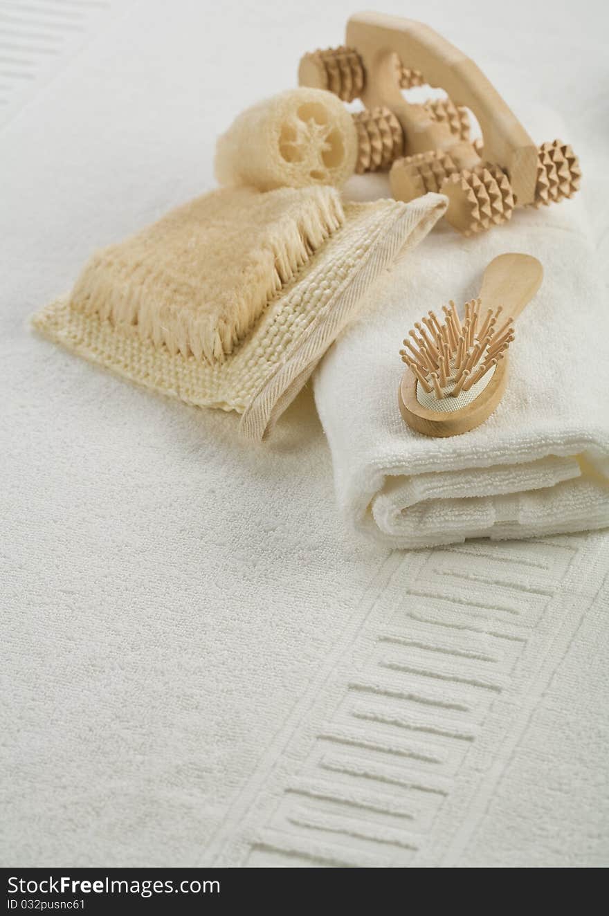 Massager bath hairbrush and towel on white towel. Massager bath hairbrush and towel on white towel