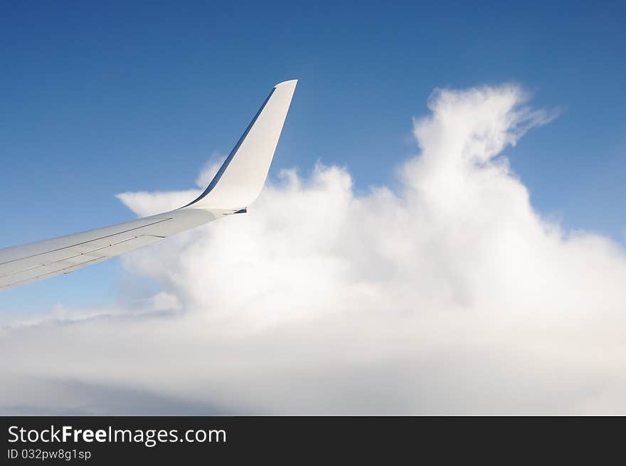 View of plane window with clouds