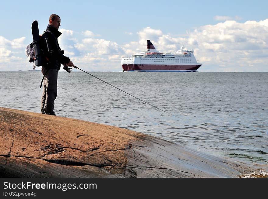 A fisherman angling on the sea