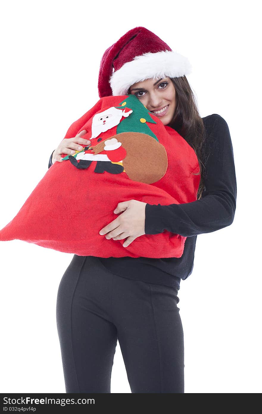 A young woman holding a christmas shopping bag with a christmas hat. A young woman holding a christmas shopping bag with a christmas hat