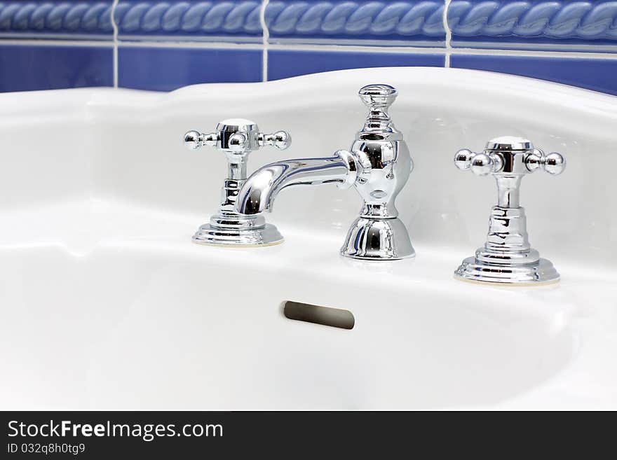 Faucet and sink - new luxury bathroom close-up. Faucet and sink - new luxury bathroom close-up