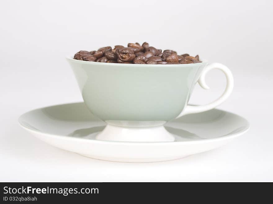 Coffee Beans in Cup with Saucer