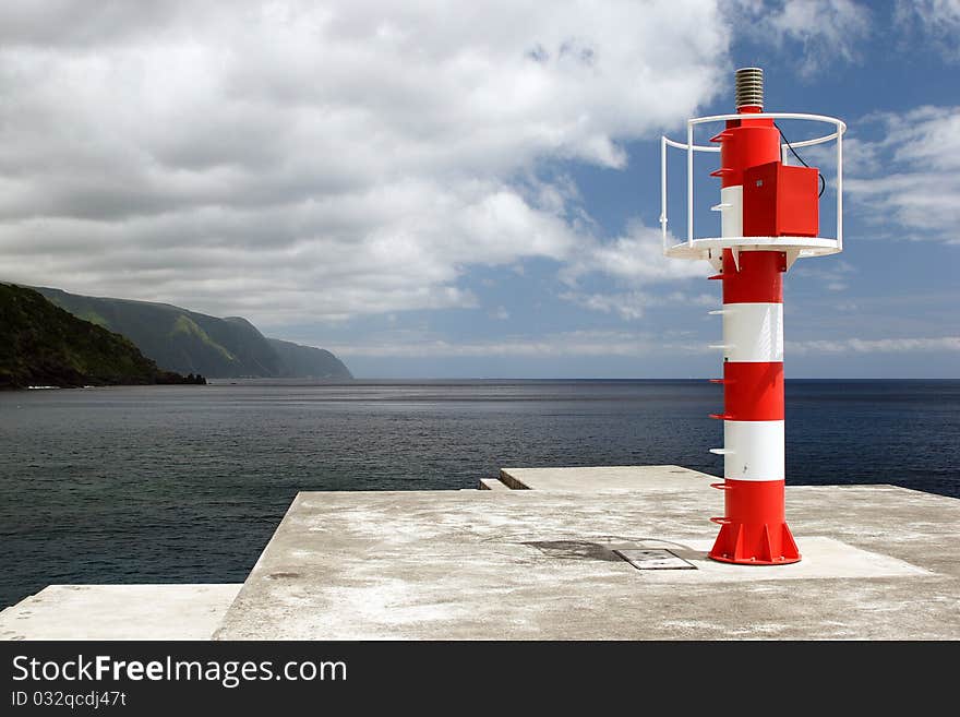 The red white striped beacon on coast