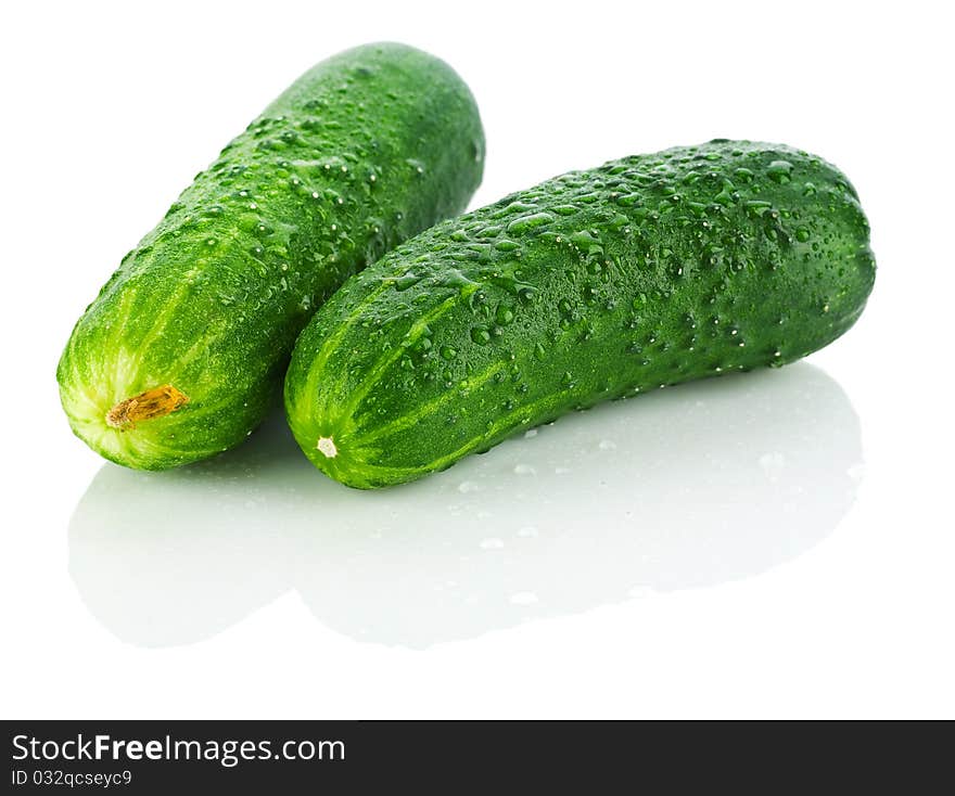 Fresh dropped cucumbers isolated on white background