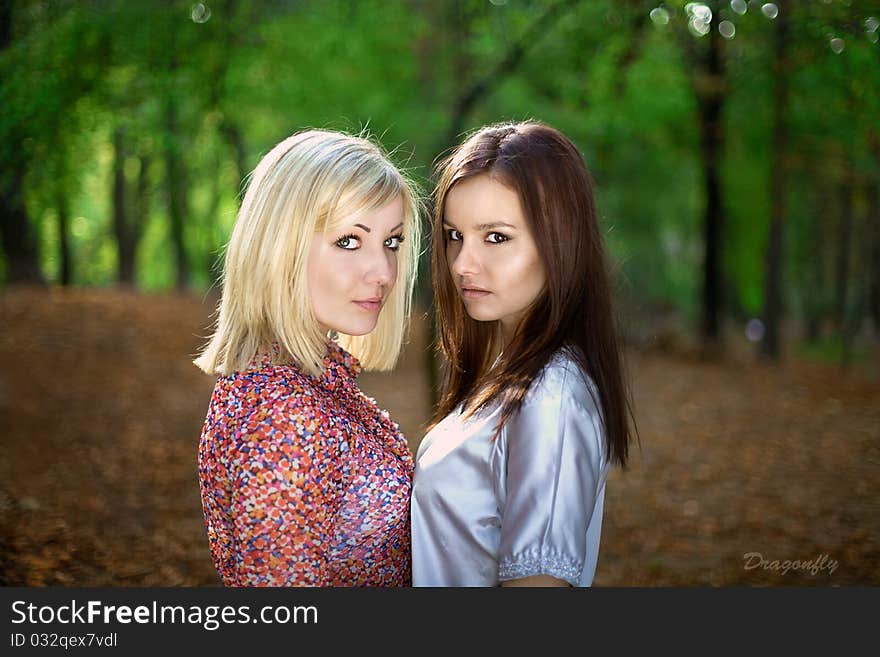 A Beautiful Blonde And Brunette Girls In Forest