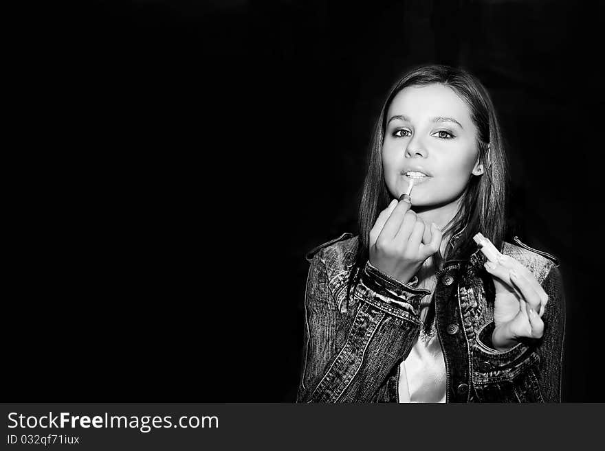 Girl and makeup on a black background